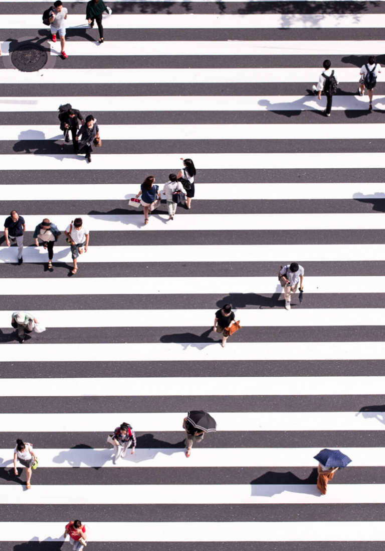 In this image, we see a very large pedestrian with individuals crossing it.
