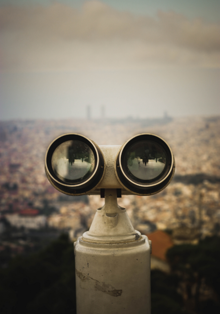 In this image, we can see panoramic binoculars, oriented towards the city, in the background.